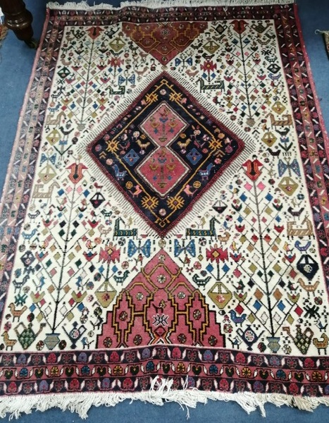 A Persian ivory ground rug 125 x 175cm